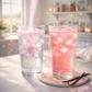 DreamPop pink cream soda loaded tea powder pouring into sparkling iced drink beside finished pastel pink potion in cozy magical kitchen setting

