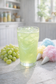 Gossamer Dew glitter green grape cotton candy loaded tea in sparkling pastel green iced glass with magical shimmer and dreamy candy styling